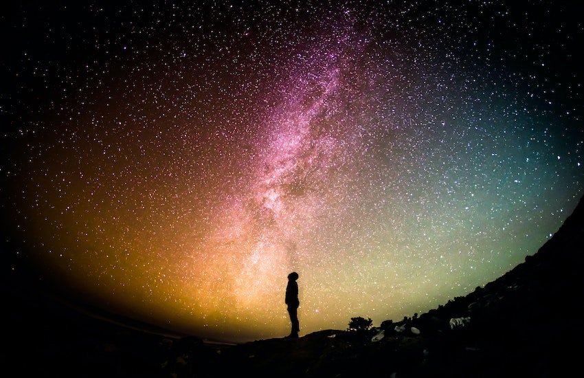 Photo of person looking into the night sky