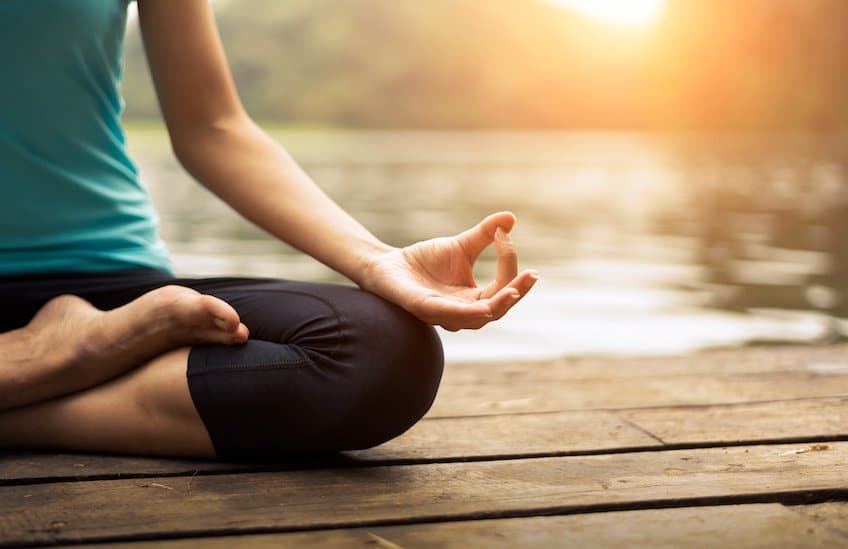 Close up hand. Woman do yoda outdoor. Woman exercising yoga at the nature background, select focus
